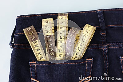 Yellow measuring tape in jeans pocket image of body slimming Stock Photo