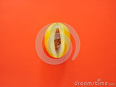 Yellow Melon Fruit isolated in orange background viewed from above - flatlay look - Image Stock Photo