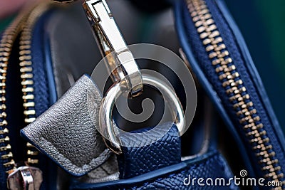 Yellow metal carabiner with a ring with blue leather harness Stock Photo