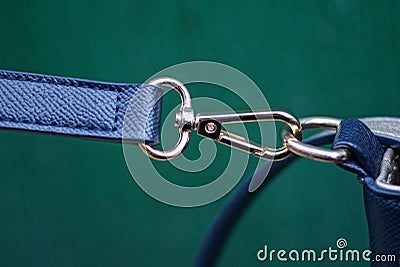 Yellow metal carabiner with a ring with blue leather harness Stock Photo