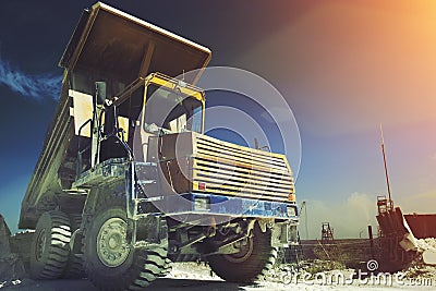 Yellow mining truck. Work industrial machinery, limestone mining. Sun light effect Stock Photo