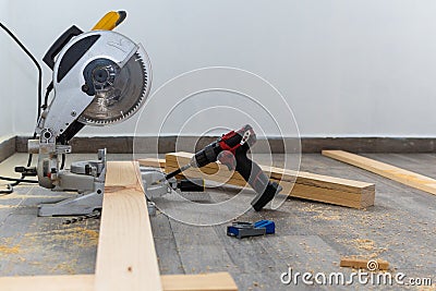 Yellow miter saw cutting wood Stock Photo