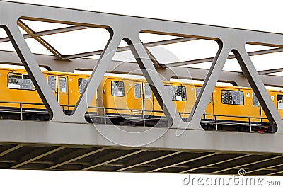 Yellow moving train on an iron bridge with blue sky, isolated on Stock Photo