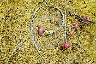 Yellow net for fishing with rope and red benefits Stock Photo