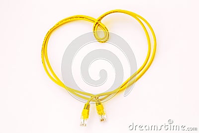 Yellow network cable folded in the shape of a heart isolated on white. Safer Internet Day. World Telecommunication and Information Stock Photo