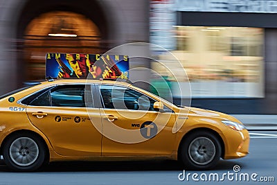 A yellow new york taxi driving by Editorial Stock Photo