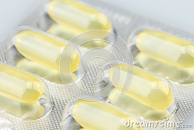 Yellow omega three tablets in one pack Stock Photo