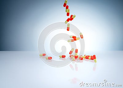 Yellow-orange capsules pill falling down on white table. Pharmaceutical industry. Drug interactions, side effect, and adverse drug Stock Photo