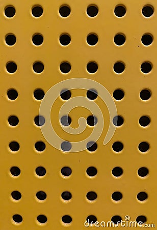 Yellow, orange iron perforated sheet. Stock Photo