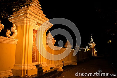 A yellow orange lit wall and doorway at night in Phnom Penh Cambodia, South East Asia Editorial Stock Photo