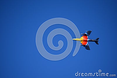 Yellow, Orange, Red and Blue Fighter Aircraft flying Left Stock Photo