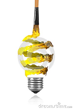 Yellow orange spiral paint trace and paintbrush made light bulb Stock Photo