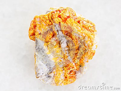 yellow Orpiment on dolomite stone on white Stock Photo