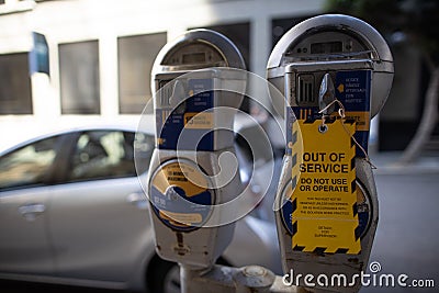 Yellow out of service tag attached on faulty damage of defect car parking metre Stock Photo