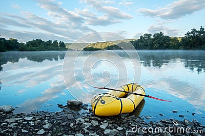 Yellow packraft boat on sunrise river Dnister Stock Photo