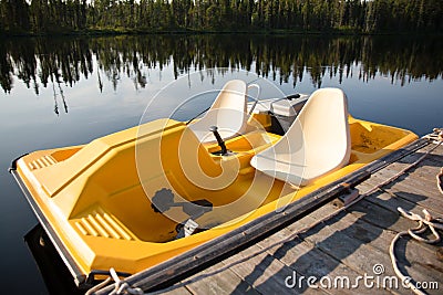 Yellow Paddle Boat In the Summer on a Lake Stock Photo