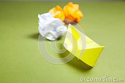 yellow paper boats and reams of paper Stock Photo