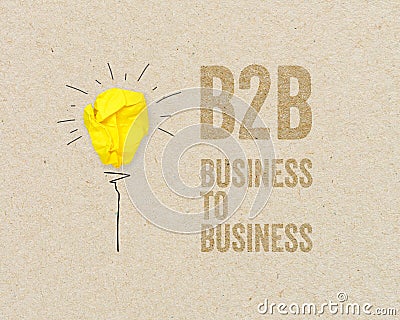 Yellow paper light bulb with B2B - Business to business on brown recycled paper background Stock Photo