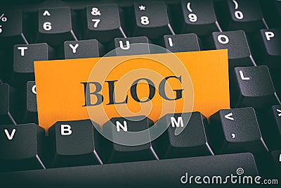 Yellow paper note on black keyboard with writing Blog Stock Photo