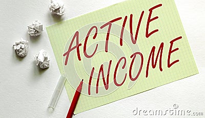Yellow paper with text Active Income on the white with red marker Stock Photo