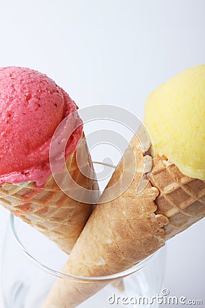 Yellow passion fruit and red strawberry ice cream cones Stock Photo