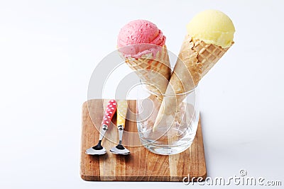 Yellow passion fruit and red strawberry ice cream cones Stock Photo