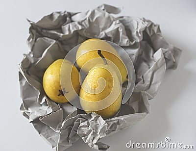 Yellow pears in paper Stock Photo