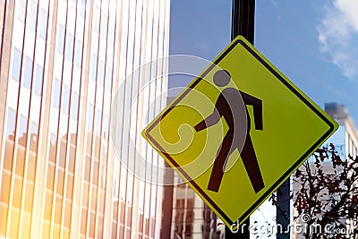 Yellow pedestrian traffic diamond shaped sign Stock Photo