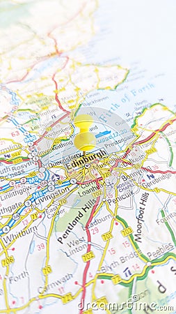 A yellow pin stuck in Edinburgh on a map of Scotland portrait Stock Photo