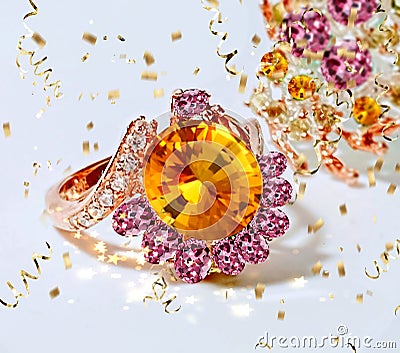 Yellow Citrine pink gemstone gold ring with white crystal and gold confetti on white background fashion jewelry women accessories Stock Photo