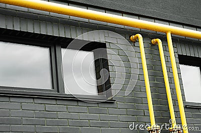 Yellow pipes, black wall and window Stock Photo