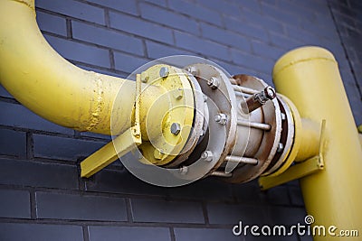 Yellow pipes, black wall Stock Photo