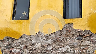 Yellow plaster and rubble rock wall, Mexico Stock Photo