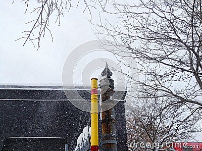 Yellow pole and snow Stock Photo
