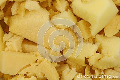 Yellow polyurethane foam rubber pieces background texture. stuffing for pillows and furniture Stock Photo