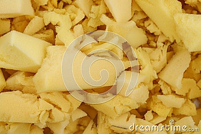 Yellow polyurethane foam rubber pieces background texture. stuffing for pillows and furniture Stock Photo