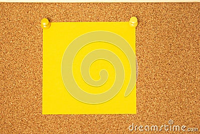 Yellow post-it on a coarkboard background Stock Photo