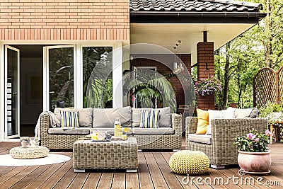 Yellow pouf on wooden patio Stock Photo