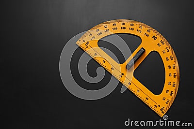 Yellow protractor on blackboard, top view. Space for text Stock Photo