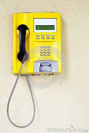 Yellow public telephone Stock Photo