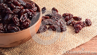 Yellow raisins on the sack background Stock Photo