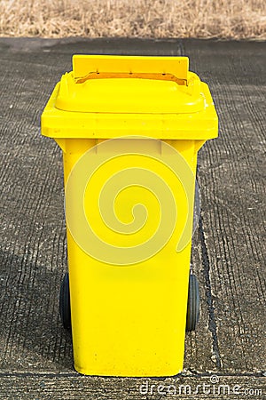 Yellow recycling bin Stock Photo