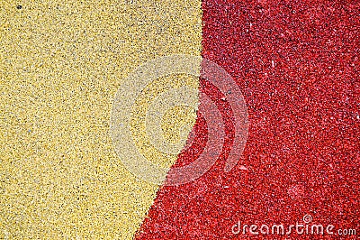 Yellow and red bright soft soft rubber flooring safe for sports and workout or on the playground from the many small round Stock Photo