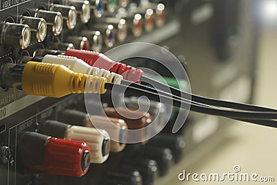 Yellow, red and white audio cables and connectors on music amplifier back panel Stock Photo
