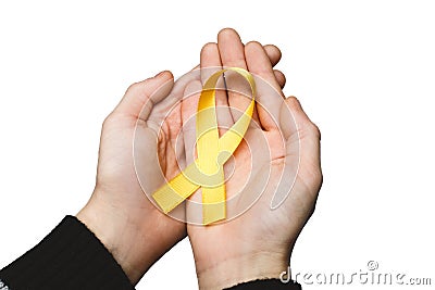 Yellow ribbon in hands, symbol Bladder cancer, Sarcoma, Bone can Stock Photo