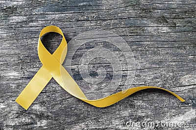 Yellow ribbon symbolic color for Sarcoma Bone cancer awareness and suicide prevention on aged wood isolated with clipping path Stock Photo