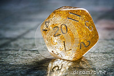Yellow role playing game twenty sided dice close-up. Board game and rpg concept with copy space Stock Photo
