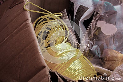 Yellow rope in the cardboard. Usually used to tie objects to be carried more easily and neatly Stock Photo