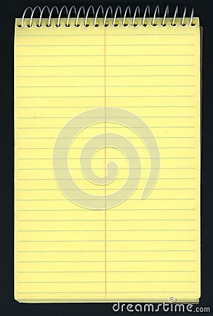 Yellow ruled spiral notepad over black Stock Photo