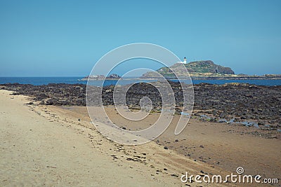 Yellow sand beach and white lighthouse on the island Stock Photo